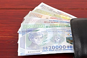 Guinean money in the black wallet