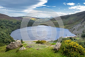 Guiness Lake with moored Viking longships and wooden village in Wicklow Mountains