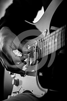 A guitar being played by a male.