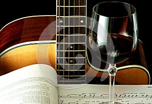 Guitar, book and wineglass
