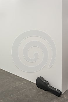 Guitar case and white wall