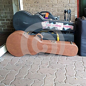 guitar cases on path in front of building