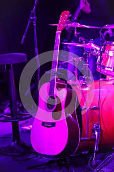 Guitar with drums under violet light