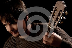 Guitar fingerboard and guitarist photo