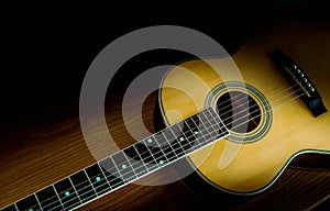 Guitar folk on a wooden floor with beautiful light.