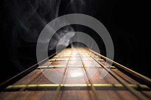 Guitar fretboard against dark background