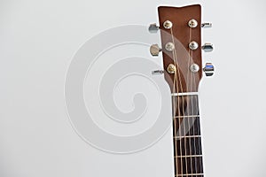 Guitar fretboard close-up, view of the neck of the guitar and strings on white