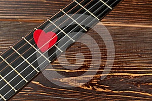 Guitar fretboard with red heart.