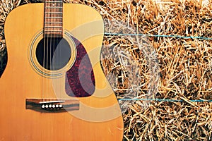 Guitar on a hay stack
