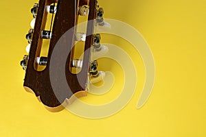 Guitar head closeup on yellow