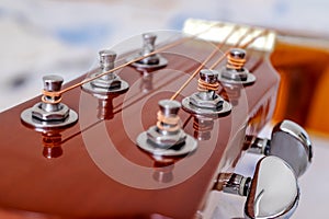 Guitar head with tuning heads and pegs.