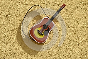Guitar instrument on textured wall