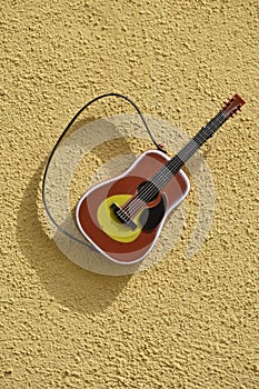 Guitar instrument on textured wall