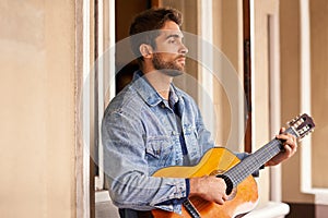 Guitar, music and instrument for thoughtful male person, outside on patio or veranda. Acoustic, singer and talent for