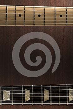 Guitar necks over wooden background