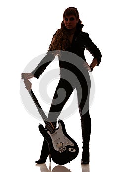 Guitar next to female legs in leather leggings