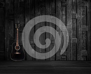 Guitar on old wooden wall.