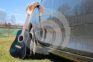 Guitar outdoor near car