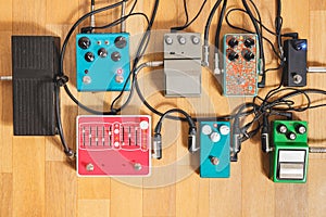 Guitar pedalboard on the floor of a recording studio.