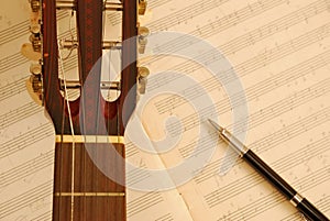 Guitar with pen on music manuscript