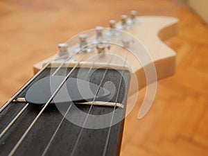 Guitar pick between the strings