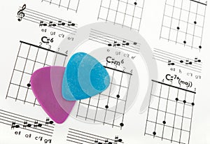 Guitar picks on a chords chart