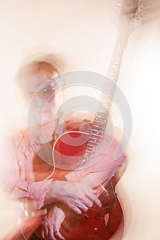 Guitar Player With Acoustic Guitar. Shot with Combination of Strobes and Halogen Light to Create Mood and Atmosphere. Mixture