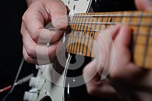 Guitar player on black background photo