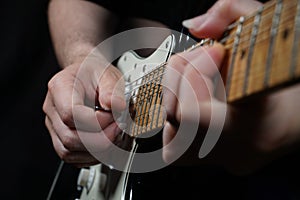 Guitar player on black background photo