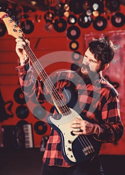 Guitar player concept. Musician with beard play electric guitar