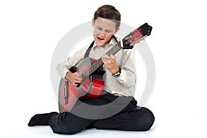 Guitar player performing very passionately on a white back