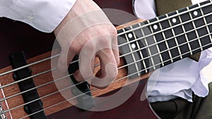 Guitar player on stage at a concert rocking the audience. Closeup of guitarist playing riffs