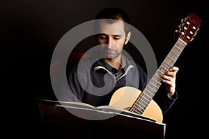 Guitar player studying with music stand