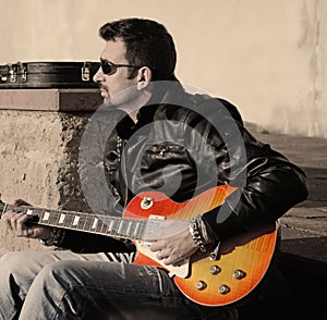 Guitar player at sunset in vintage tone