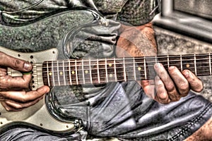 Guitar player tonemapped in faded color photo