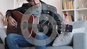 guitar playing creative hobby guy tuning strings