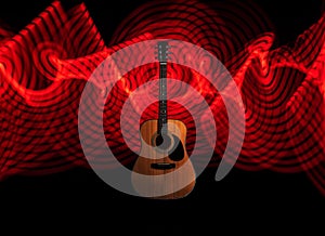 Guitar with red light painting in the background