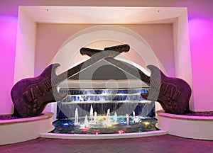 guitar sculpture decor with illuminated fountain water