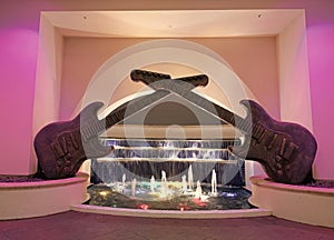 guitar sculpture decor with illuminated fountain water