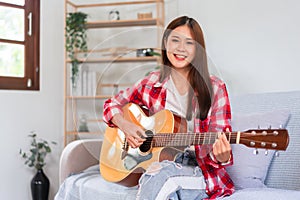 Guitar and singer concept, Young woman playing music acoustic guitar and smile to looking at camera