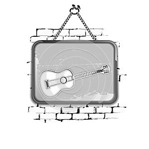 Guitar stencil pattern in a frame on brick wall monochrome