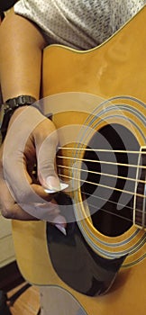 Guitar and string steel with finger strumming with white pick