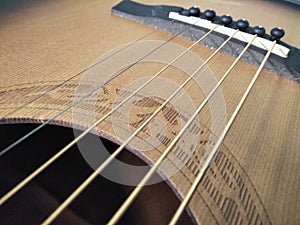 Guitar strings on an acoustic guitar.