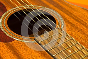 Guitar strings and rosette close up - brown top / soundboard