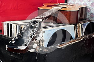 Guitar on a trunk full of old vinyl records