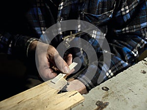 Guitars Luthiers cuts off part of the saddle. photo