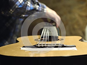 Guitars Luthiers sets the strings on a guitar. photo