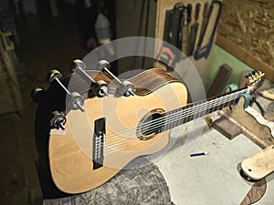 Guitars Luthiers sets up a stand under the arm. photo