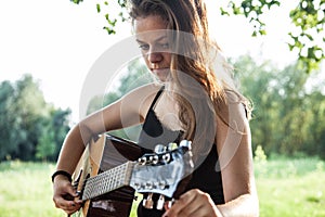 Guitarist adjusting tuning pegs