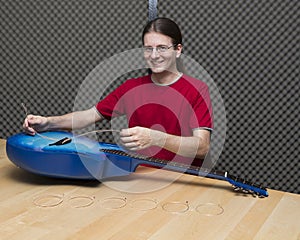 Guitarist changing the guitar strings